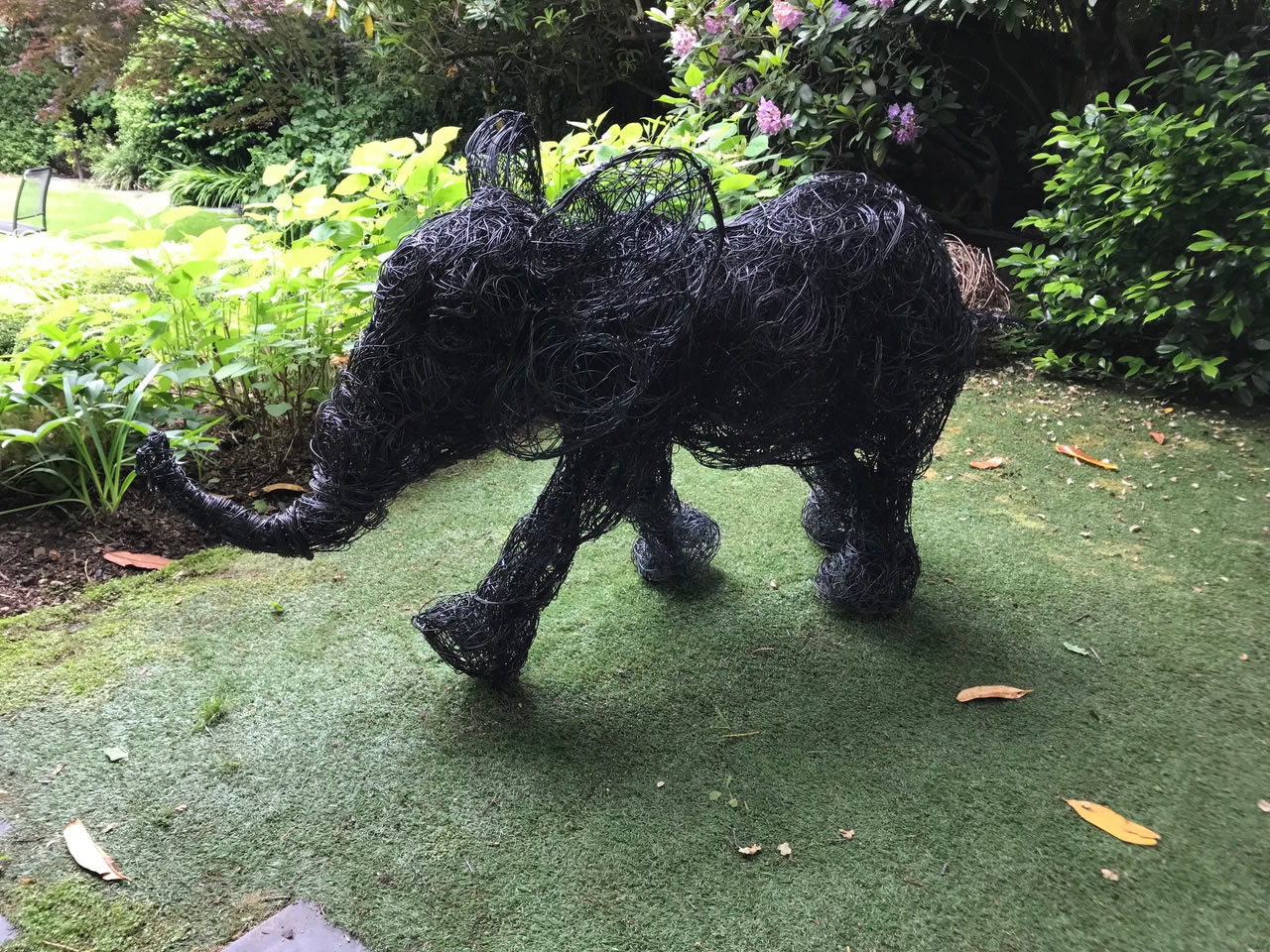 Jumbo, copper wire sculpture baby elephant seen at the 2018 Chelsea Flower Show installed in a garden in Hampstead, North London